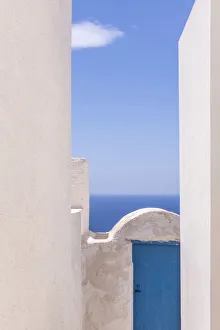 Images Dated 9th August 2021: Europe, Greece, Thirasia. White building and blue door and ocean