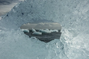 Images Dated 31st May 2013: Europe, Iceland, Breidamerkursandur. Icebergs viewed through hole in ice. Credit as