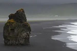 Images Dated 22nd July 2012: Europe, Iceland, Vik. Basalt column rises from black sand beach on rainy day. Credit as