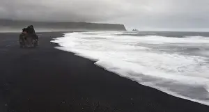 Basalt Prints: Europe, Iceland, Vik. Basalt column rises from black sand beach on rainy day. Credit as