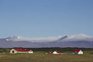 Joan Loeken Prints: Europe, Iceland, West Fjords, scenic landscape of barn and houses in foreground against mountains