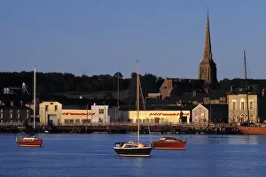 Church Tower Prints: Europe, Ireland, Wexford. Late golden light plays off the boats and buildings on Wexford Harbor
