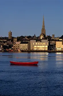 Church Tower Prints: Europe, Ireland, Wexford. Late light over Wexford harbor illuminates the windows