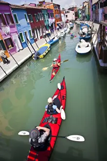 Images Dated 12th May 2010: Europe; Italy; Burano; Bright Colored Homes Along the Canal with Kyakers Traveling