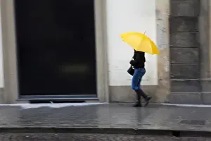Rainy Prints: Europe; Italy; Florence; Woman walking in the rain on the streets of Florence