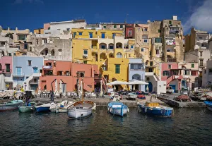 Europe, Italy, Procida. City houses and boats in Marina Corricella