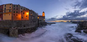 Images Dated 9th August 2021: Europe, Italy, Tellaro. Panoramic of village and sea at sunset