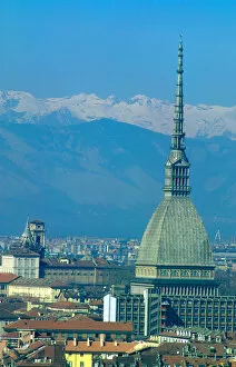 Europe, Italy, Turin. The tower of the Mole with the snow capped peaks of the Dolomites