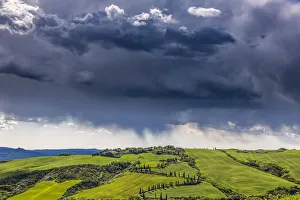 Stormy Prints: Europe, Italy, Val d Orcia. Storm clouds over Tuscany landscape