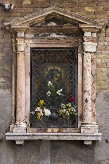 Europe, Italy, Venice. Devotional niche to Virgin Mary on street wall. Credit as