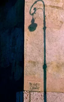 Europe, Italy, Verona. Shadow of street lamp on wall
