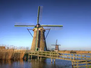 Multicolor Prints: Europe; Netherlands; Kinderdijk; Sunrise along the canal with Windmills