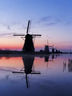 Europe; Netherlands; Kinderdijk; Windmills at Sunrise along the canals of Kinderdijk