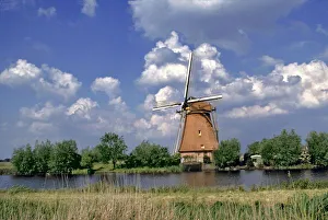 South Holland Prints: Europe, Netherlands, Kinerdijk. A windmill sits on the edge of the canal at Kinderdijk