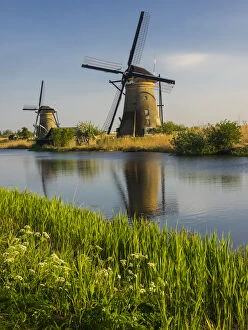 Netherlands, Holland Gallery: Europe; Netherleands; Kinderdyk; Windmills with evening light along the canals of Kinderdijk