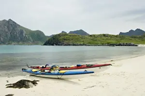 Europe, Norway, Vesteralen. Sea kayaks on beach at Hovden