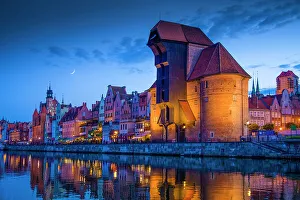 Poland Prints: Europe, Poland, Gdansk. Moon composite and city buildings reflecting in river at sunset