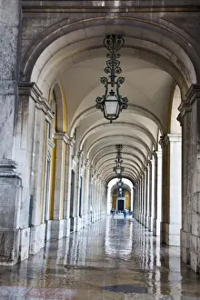 Europe; Portugal, Lisbon. Columns of the Arcade of Commerce Square with reflections