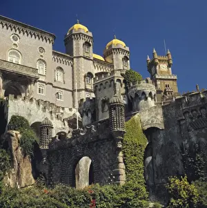 Royalty Prints: Europe, Portugal, Sintra. The yellow roofs of the towers of Pena Palace shine in the sun in Sintra