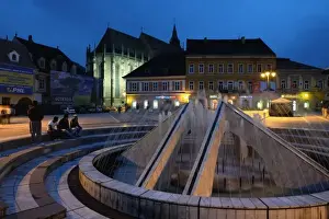 Brasov Prints: Europe, Romania, Brasov, The night view of fountain on the Sfatului square with