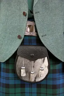 Expensive Prints: Europe, Scotland. Classic Scottish tartan attire with sporran (pouch or bag). THIS