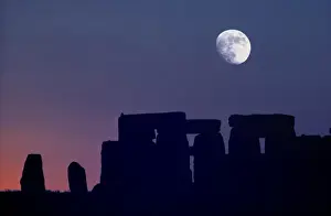 Moon Set Prints: Europe, Stonehenge. The moon sets over prehistoric Stonehenge, a World Heritage Site