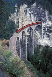 Images Dated 18th January 2006: Europe, Switzerland, Bernina Region, passenger train on the tallest rock bridge in