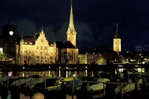 Europe, Switzerland, Zurich. Grossmunter City and Limmat River view from Utoquai, evening
