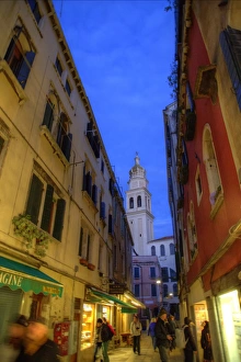 Carnival Prints: Evening street scene with Bell Tower in background, Venice Italy