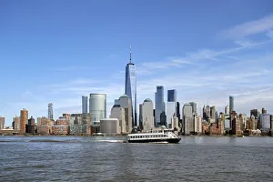 Prints of A ferry on the Hudson River passes by One World Trade Center and Manhattan buildings Images Dated 2018 December: A ferry on the Hudson River passes by One World Trade Center and Manhattan buildings