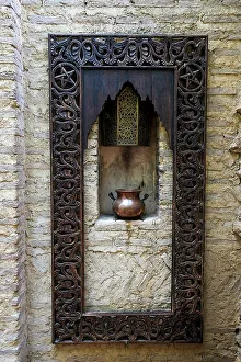 Medina Prints: Fes, Morocco. Old copper pot sits on a ledge with a carved wooden frame