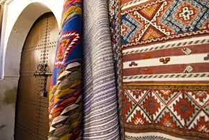 Carpet Prints: Fez Morocco decorative door and hanging patterned carpets in the old medina