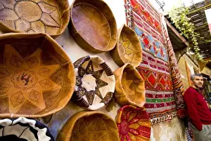 Images Dated 27th October 2008: Fez Morocco leather baskets & Oriental carpet and proprietor in the old medina