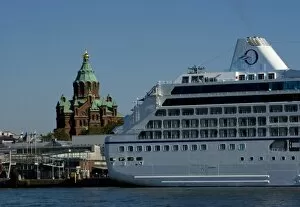 Finland, Helsinki. Oceania Insignia cruise ship with Uspenski Cathedral in background
