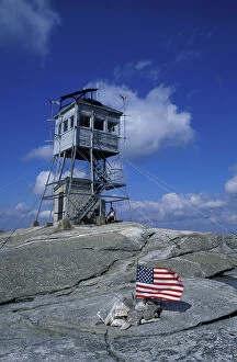 The fire tower on the summit of Mt. Cardigan in Mt. Cardigan State Park. American flag