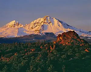 Outcrop Prints: First light gives delicate color to the Middle and North Sister in the Oregon Cascades