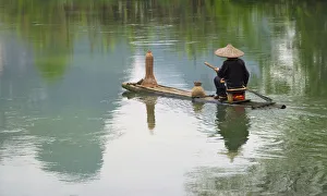 Bamboo Prints: Fisherman on bamboo raft on Mingshi River with karst hills, Mingshi, Guangxi Province