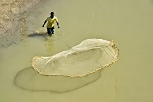 Fish Prints: Fisherman casting fish net on the river, Chittagong, Bangladesh