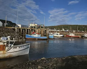 Fishing boats docked at low at in the Bay of Fundy town of Alma, New Brunswick, Canada
