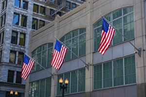 Patriotism Prints: Flags hanging outside an office building in downtown, Chicago, Illinois, USA