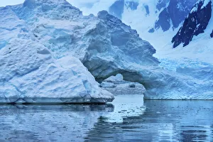 Antarctica Collection: Floating blue iceberg arch reflection, Paradise Bay, Skontorp Cove, Antarctica