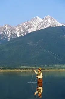 Life Style Prints: Fly fishing at Ninepipes Reservoir NWR with Mission Mountains in background in Montana