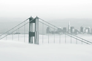 Images Dated 13th November 2007: Fog rolls through the San Francisco bay covering the Golden Gate Bridge and city