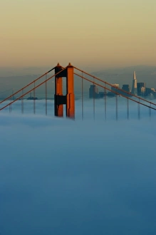 Images Dated 13th November 2007: Fog rolls through the San Francisco bay covering the Golden Gate Bridge and city