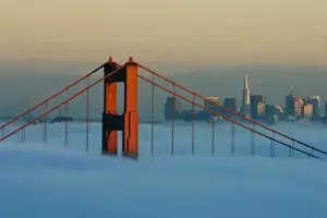 Fog rolls through the San Francisco bay covering the Golden Gate Bridge and city