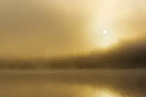 Whitefish Prints: Foggy sunrise over Beaver Lake in the Stillwater State Forest near Whitefish, Montana