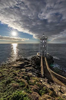 Lookout Prints: France, Brittany, Le Conquet. Sun setting at the Kermorvan Lighthouse