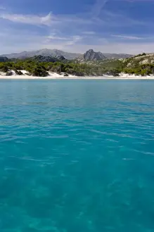 Crag Prints: France, Corsica. Clear water and white sand at Saleccio Beach below rugged terrain of DA