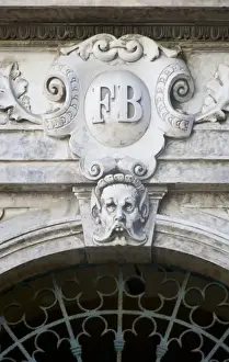 Mono Chrome Prints: France, Corsica. Grotesque face and ornate decoration on pediment above door in Ajaccio