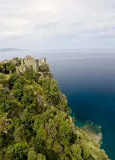 Corsica Prints: France, Corsica. Ruins of Genoese Tower above Mediterreanean Sea at village of Nonza